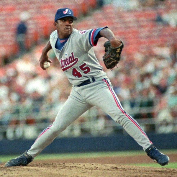 FILE - In this May 17, 1996 file photo, Montreal Expos' pitcher Pedro Martinez delivers a pitch during the first inning of a baseball game against the Pades in San Diego, Calif.  Martínez was the No. 4 starter for the 1994 Montreal Expos, who were the best team in baseball on the morning of Aug. 12 when players went on strike, leading to the cancellation of the rest of the season. Now the Washington Nationals — the former Expos — are in the World Series with a chance to accomplish what so many thought the Expos would have done 25 years ago if they got the opportunity.  (AP Photo/Mike Poche, File)