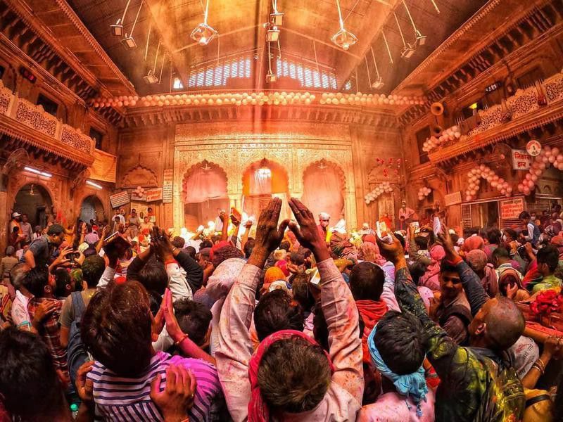 People celebrating Holi in a temple