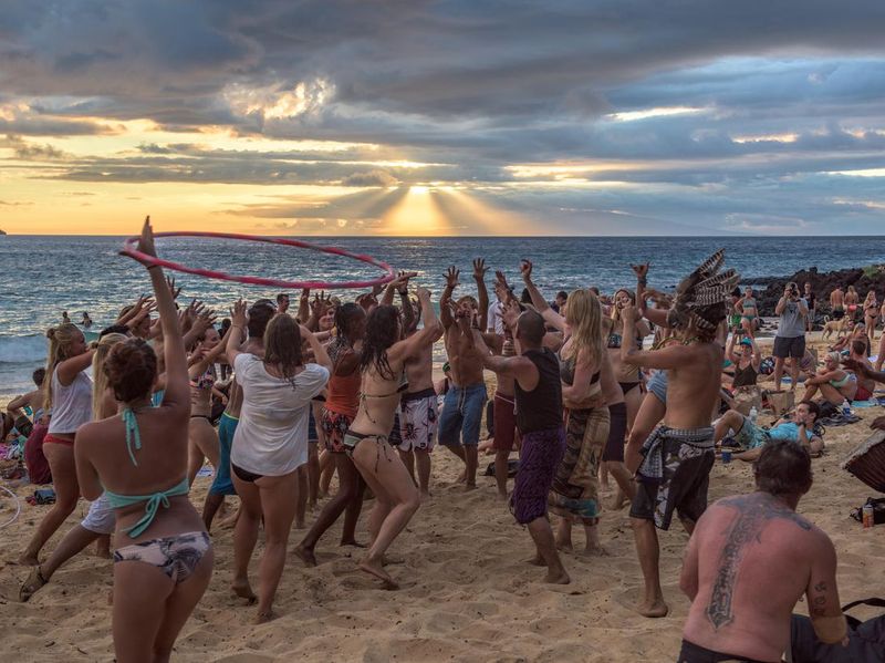 People dancing to a drum circle on Little Beach, Maui