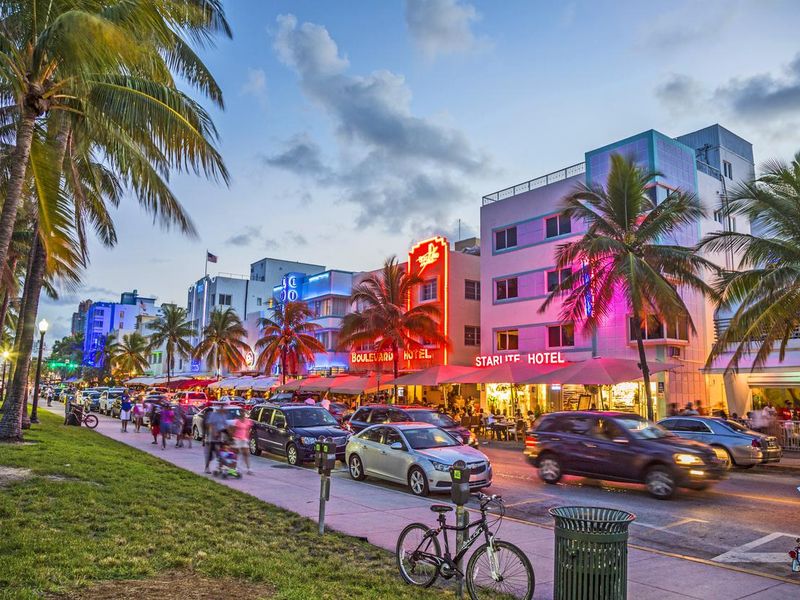 people enjoy palms and art deco hotels at Ocean Drive