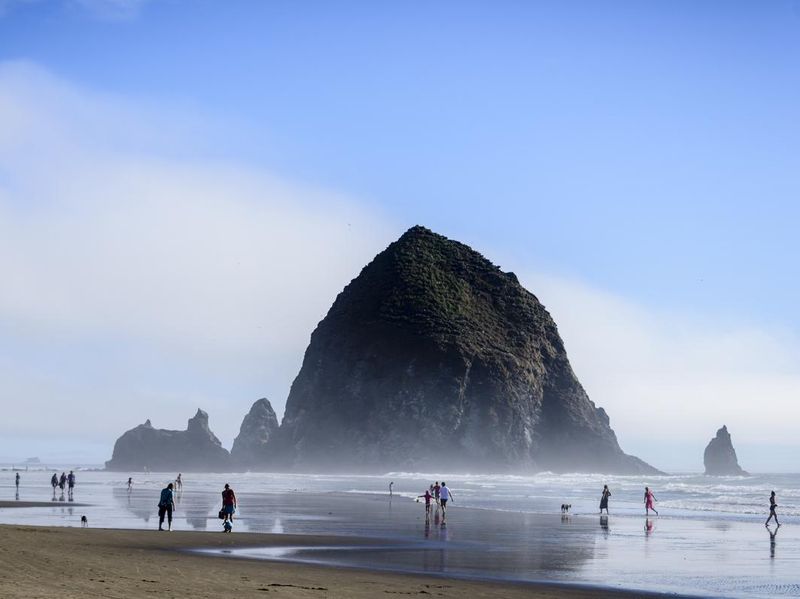 People enjoying a day at Cannon Beach, Oregon