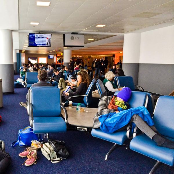 New York, USA - January 3, 2014: People sleeping on the floor at JFK Airport, New York. Thousands of flights were cancelled and delayed, all New York airports closed due to heavy snowfall.