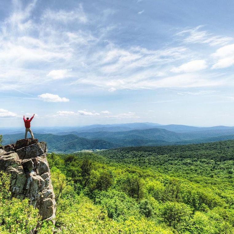 Person standing on cliff at Shenandoah National Park
