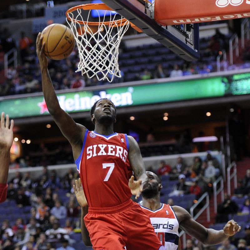 Philadelphia 76ers point guard Royal Ivey goes to basket past Emeka Okafor