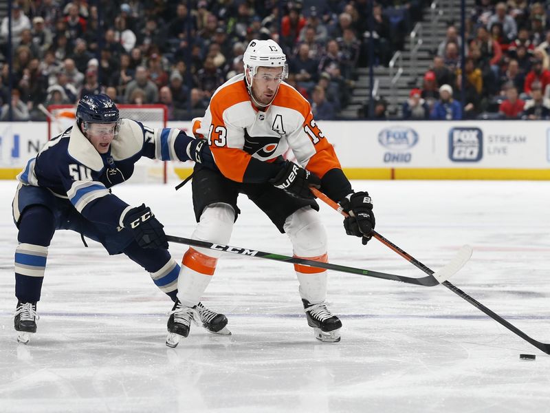Philadelphia Flyers' Kevin Hayes carries puck as Columbus Blue Jackets' Eric Robinson defends