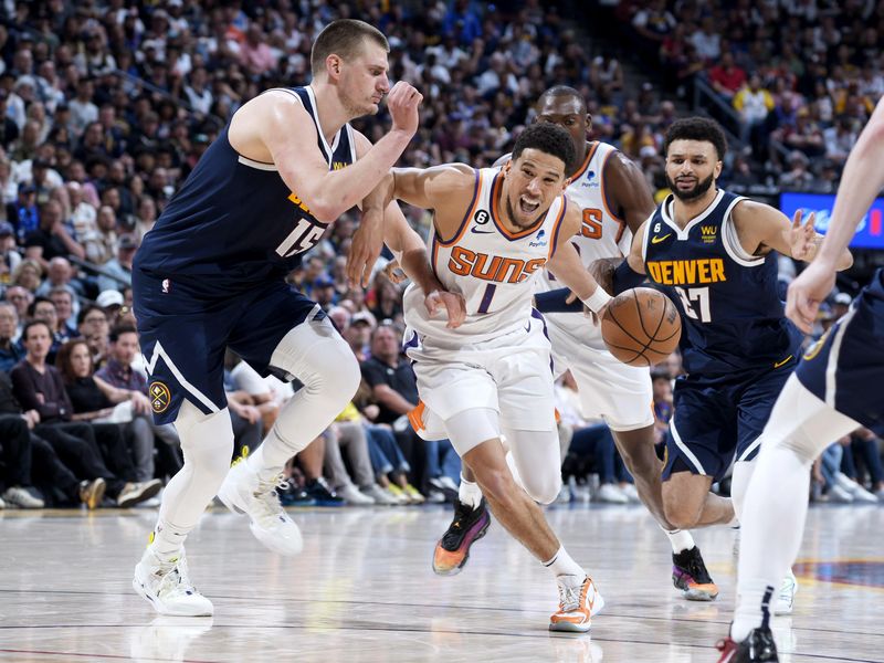 Phoenix Suns guard Devin Booker drives against Denver Nuggets center Nikola Jokic and point guard Jamal Murray