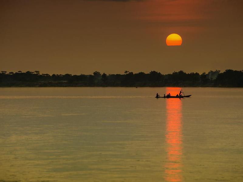 Pirogue (dugout canoe) at sunset in the Congo River