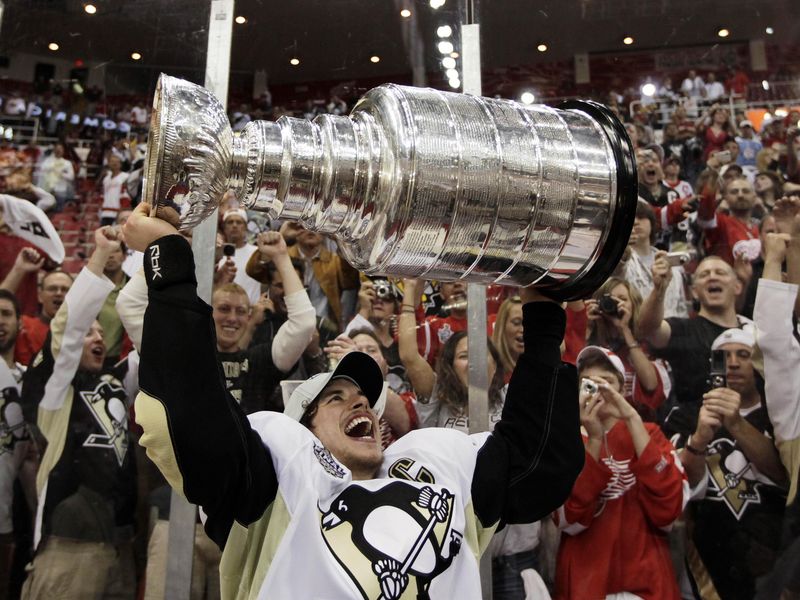 Pittsburgh Penguins' captain Sidney Crosby holds up Stanley Cup