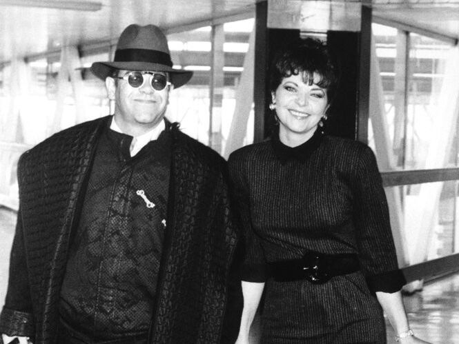 Pop star Elton John and his wife Renate arrive at London's Heathrow Airport in October 1986 from Los Angeles