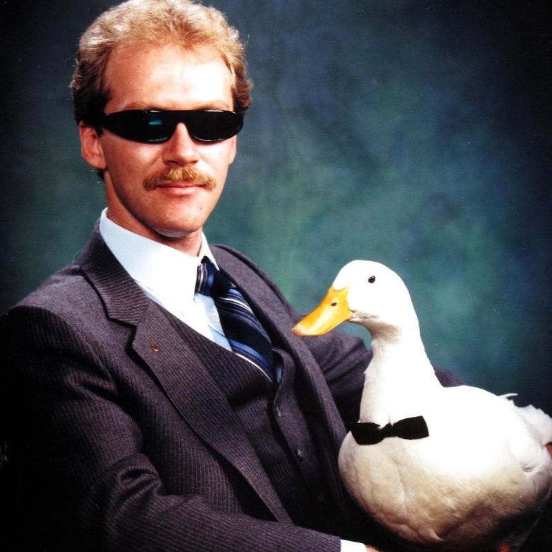 Portrait of a man with his pet duck