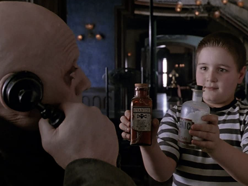 Pugsley consulting Uncle Fester about potions
