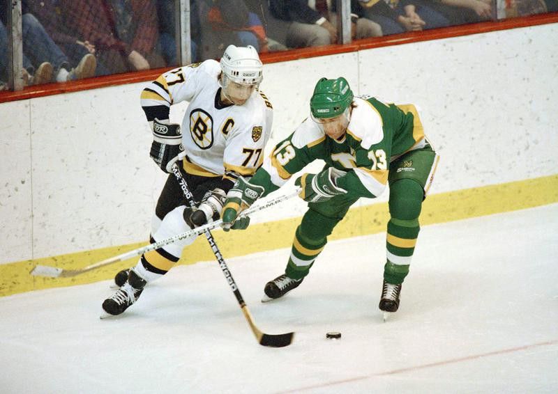 Ray Bourque skates with puck