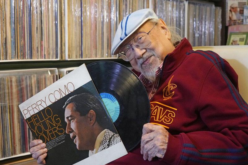 Ray Cordeiro, Hong Kong's oldest DJ, with a vinyl record