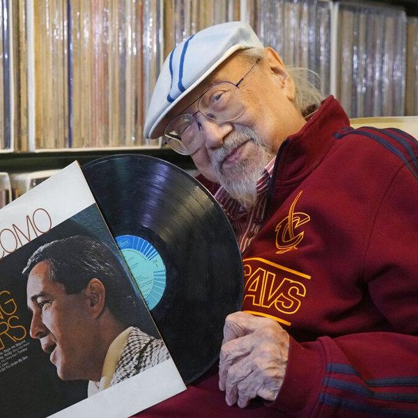 Ray Cordeiro, Hong Kong's oldest DJ shows a vinyl record at his home in Hong Kong, Thursday, May 27, 2021. Cordeiro has been named the world's "most durable DJ" by the Guinness Book of World Records, Hong Kong veteran Disc Jockey 96-yer-old Ray Cordeiro, hanged up his headphones for good after seven decades of entertaining listeners by a mix of pop oldies mainly from 60s and 70s, from the Beatles to the Rolling Stones to classics like Sinatra and Tony Bennett. (AP Photo/Kin Cheung)