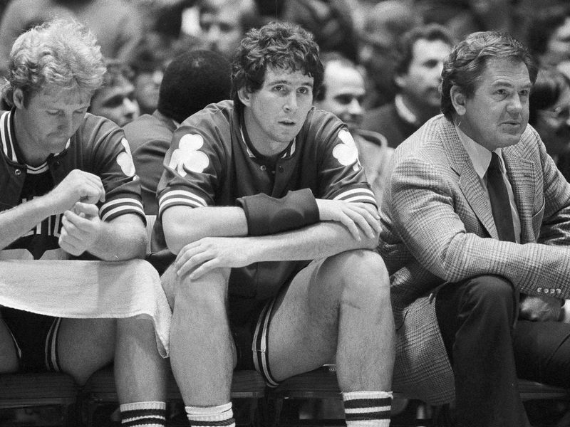 Rick Robey and Larry Bird watch from Boston Celtics bench