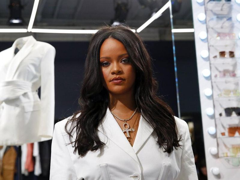 Rihanna posing. Rihanna net worth 2022 is in the billions.