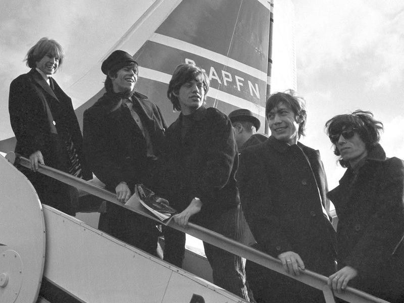 Rolling Stones on airplane stairs