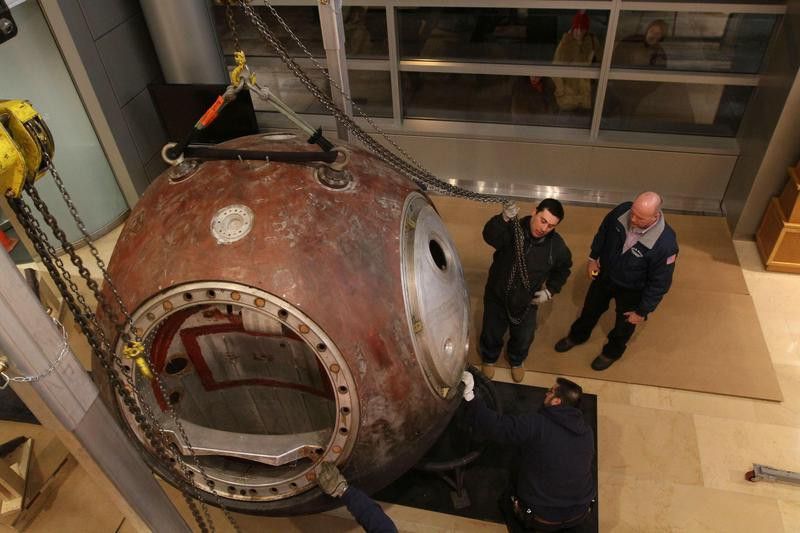 Russian astronauts with a Soviet-built Vostok capsule