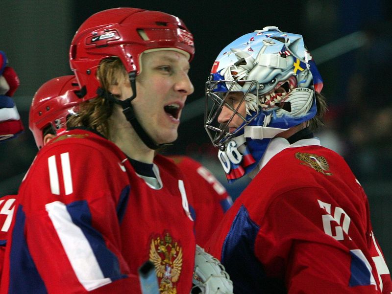Russia's Darius Kasparaitis and goaltender Evgeni Nobokov celebrate