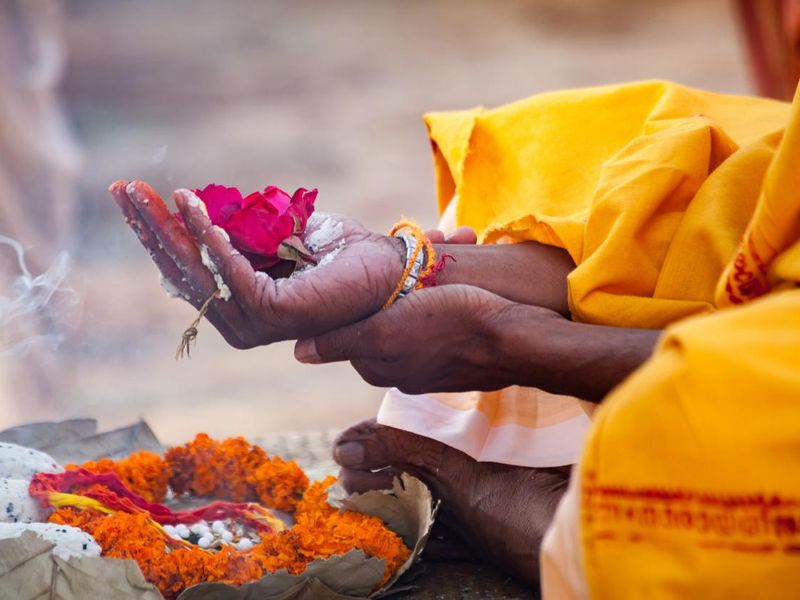 Sacred flowers are taken for worship on hand at river Ganges