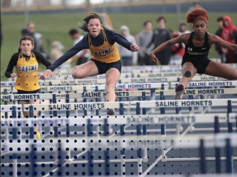 Saline High School girls hurdler competing in a track and field meet