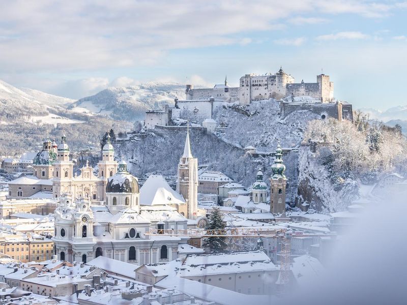 Salzburg old city and fortress in winter, snowy sunny day, Austria