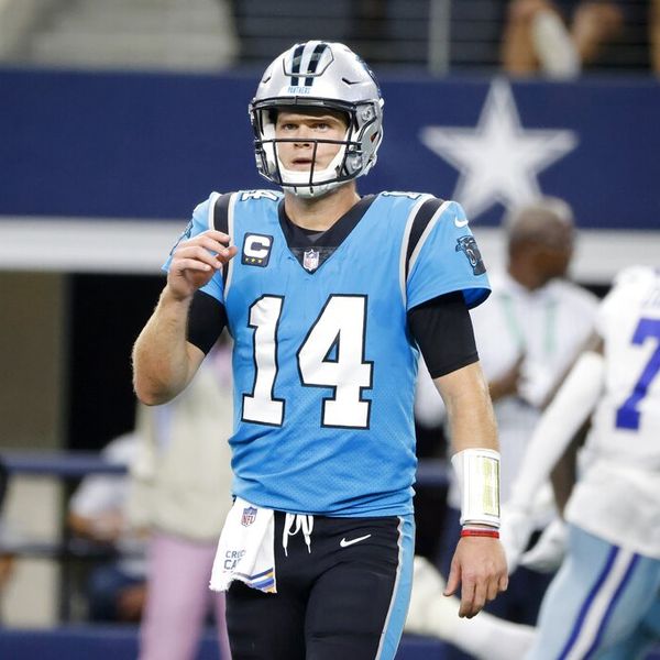 Carolina Panthers quarterback Sam Darnold walks to the sideline as Dallas Cowboys' Trevon Diggs (7) celebrates intercepting Darnold's pass in the second half of an NFL football game in Arlington, Texas, Sunday, Oct. 3, 2021. (AP Photo/Michael Ainsworth)