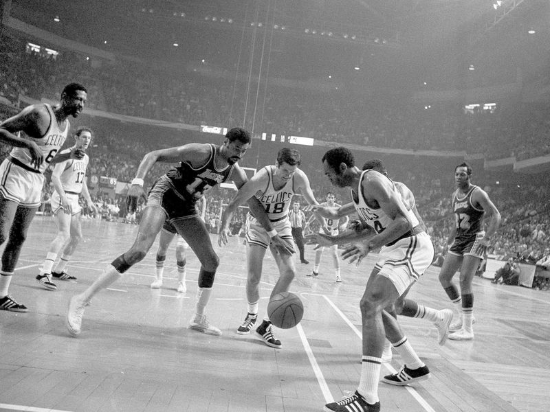 Sam Jones looks to gain control of loose ball with Bailey Howell against Wilt Chamberlain