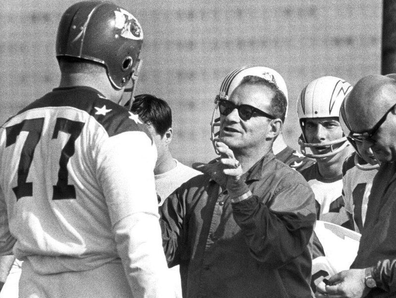 San Diego Chargers head coach Sid Gillman, center, directs American Football League All-Star and Kansas City Chiefs tackle Jim Tyrer