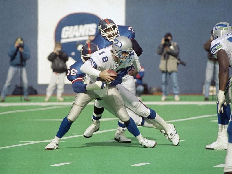 Seattle Seahawks quarter back Stan Gelbaugh gets sacked by Lawrence Taylor