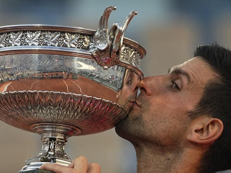 Serbia's Novak Djokovic kisses the cup