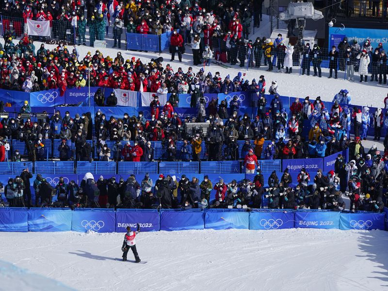 Shaun White waves after competing in men's halfpipe finals