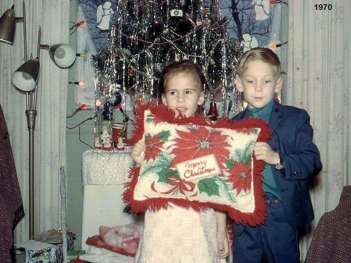 Siblings holding a holiday pillow