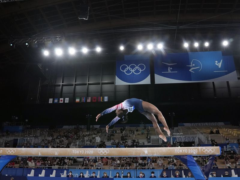 Simone Biles performs on balance beams in 2020 Summer Olympic Games