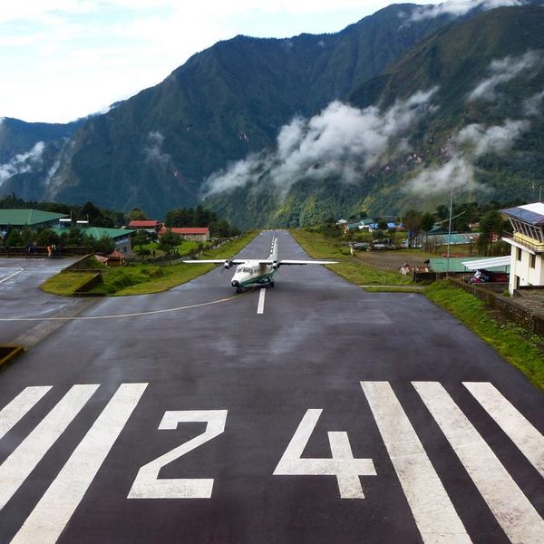 Small plane landing at the "Tenzing-Hillary" Airport in Lukla on a cloudy day, Everest Base Camp trek, Nepal