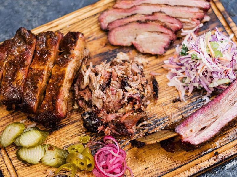 Smoked meat assortment on wooden board