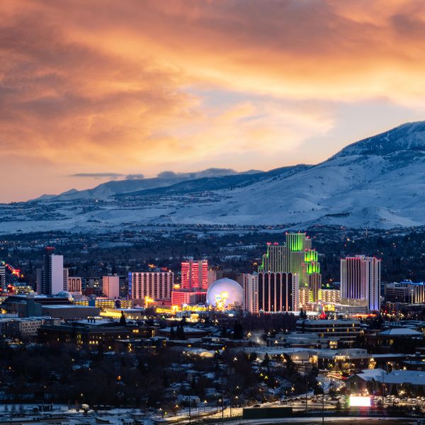 Snowy Sunset Skyline of Reno, NV with snowcapped mountains in the background