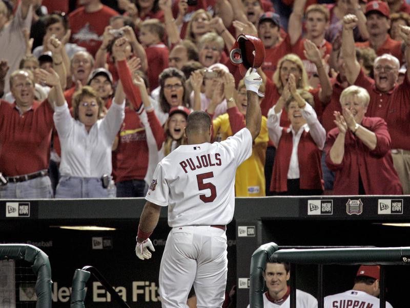St. Louis Cardinals' Albert Pujols waves to cheering fans during his curtain call