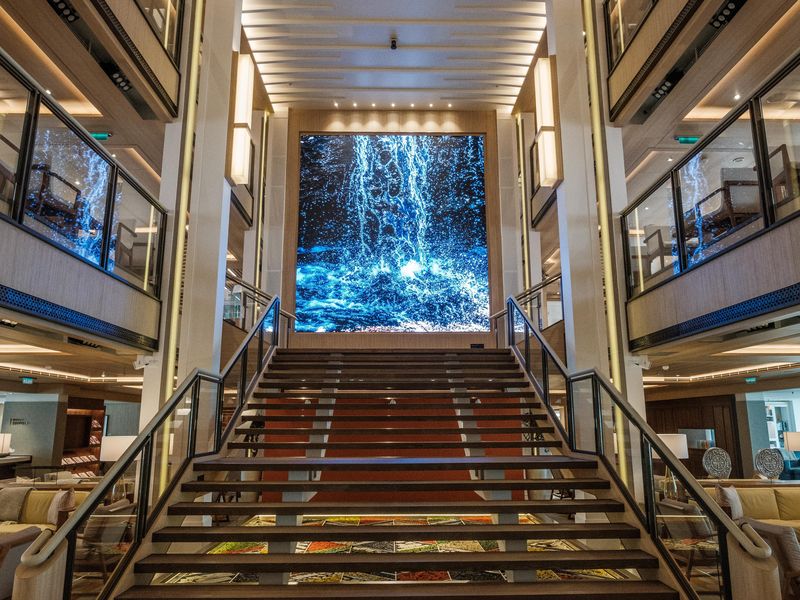 Stairs and large video screen inside the Atrium on-board the Viking Sea
