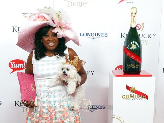 Star Jones in a Kentucky Derby hat with a dog in a hat