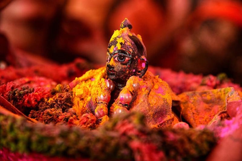Statue covered in color during Holi