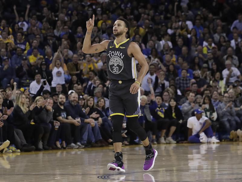 Steph Curry celebrating on court during a Golden State Warriors game