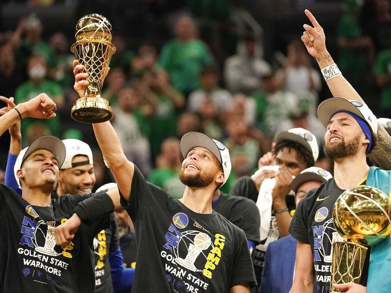 Steph Curry with Golden State Warriors teammates after winning the 2022 NBA championship.