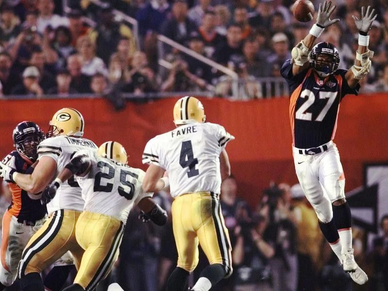 Steve Atwater jumps into air in attempt to block Green Bay Packers quarterback Brett Favre's pass
