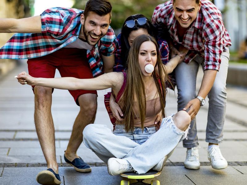 Students having fun riding a skateboard