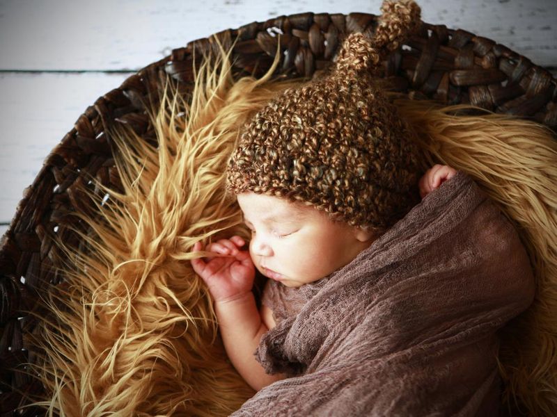 Swaddled Newborn Sleeping on Fur