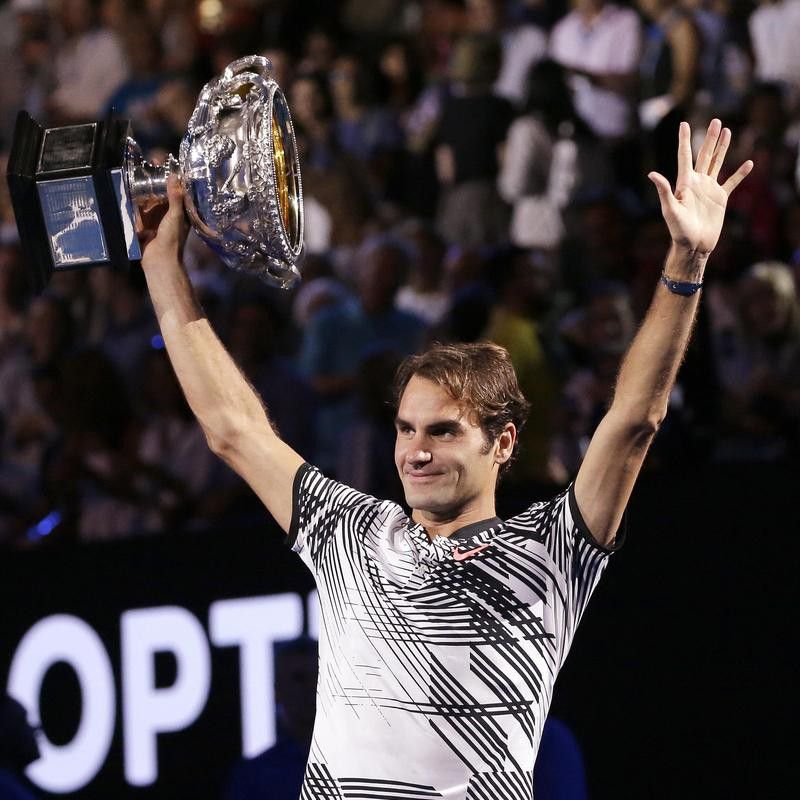 Switzerland's Roger Federer holds trophy