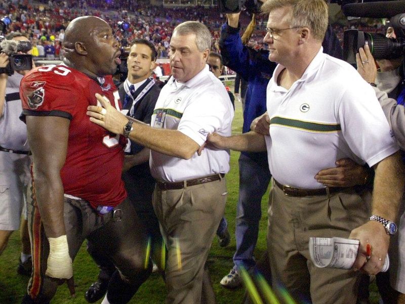 Tampa Bay Buccaneers defensive tackle Warren Sapp gives Green Bay Packers head coach Mike Sherman the business