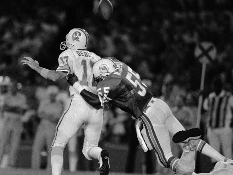 Tampa Bay Buccaneers quarterback Steve DeBerg hit hard by Miami Dolphins linebacker Hugh Green