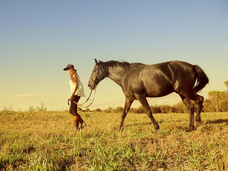 Teen girl walking her horse